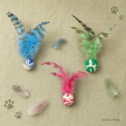 Kimi's Paws Feather Ball Toy — flat lay with 3 colour variants on linen background